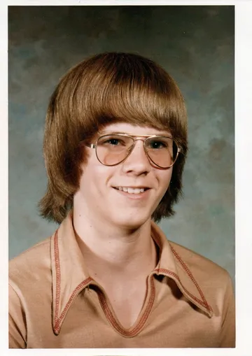 A dated school portrait from the 1970s of a young man