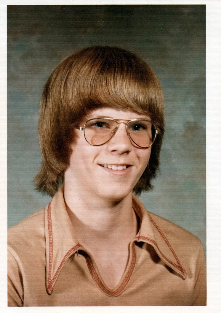 A dated school portrait from the 1970s of a young man